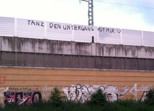 “Sponti-graffiti” spotted from the train on the way to the Wedding S-Bahn station. It says “Tanz den Untergang mit mir” (Dance [into] the downfall with me) © Virag Molnar