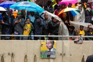 South Africans protect themselves from the rain at the memorial service for Nelson Mandela. © Chuck Kennedy | WhiteHouse.gov