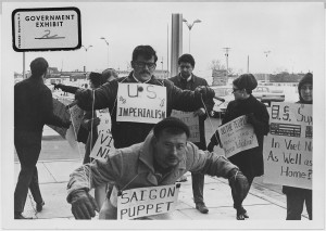 Protesters carry signs and act out "Saigon Puppet" demonstration in front of Wichita City Building, 1967 © Unknown | U.S. District Court for the Second (Wichita) Division of the District of Kansas