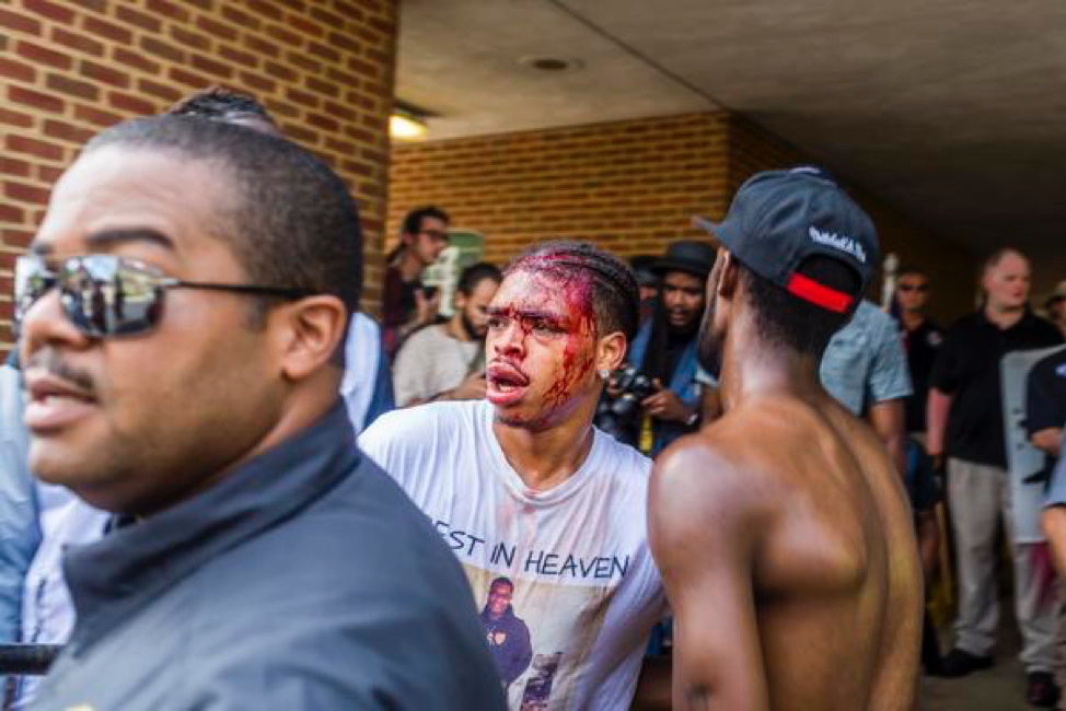 A person standing in front of a crowd

Description automatically generated