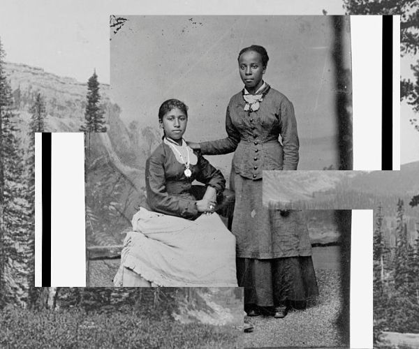 Portrait of two young African American women, one standing, one seated