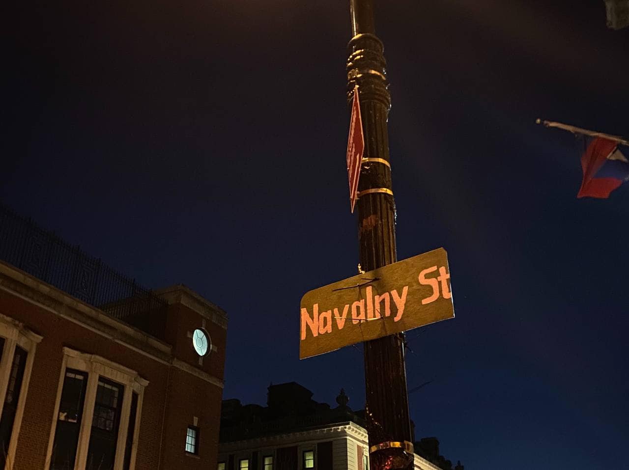A street sign as been replaced with a hand-painted with a sign reading "Navalny St" as part of a memorial outside the Consulate-General of Russia, New York City, on February 18, 2024.