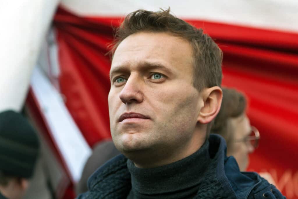 Photograph of Alexei Navalny in front of red flag at a demonstration on Russia's Unity Day, Novmeber 4, 2011. Rosfoto.ru / Shutterstock
