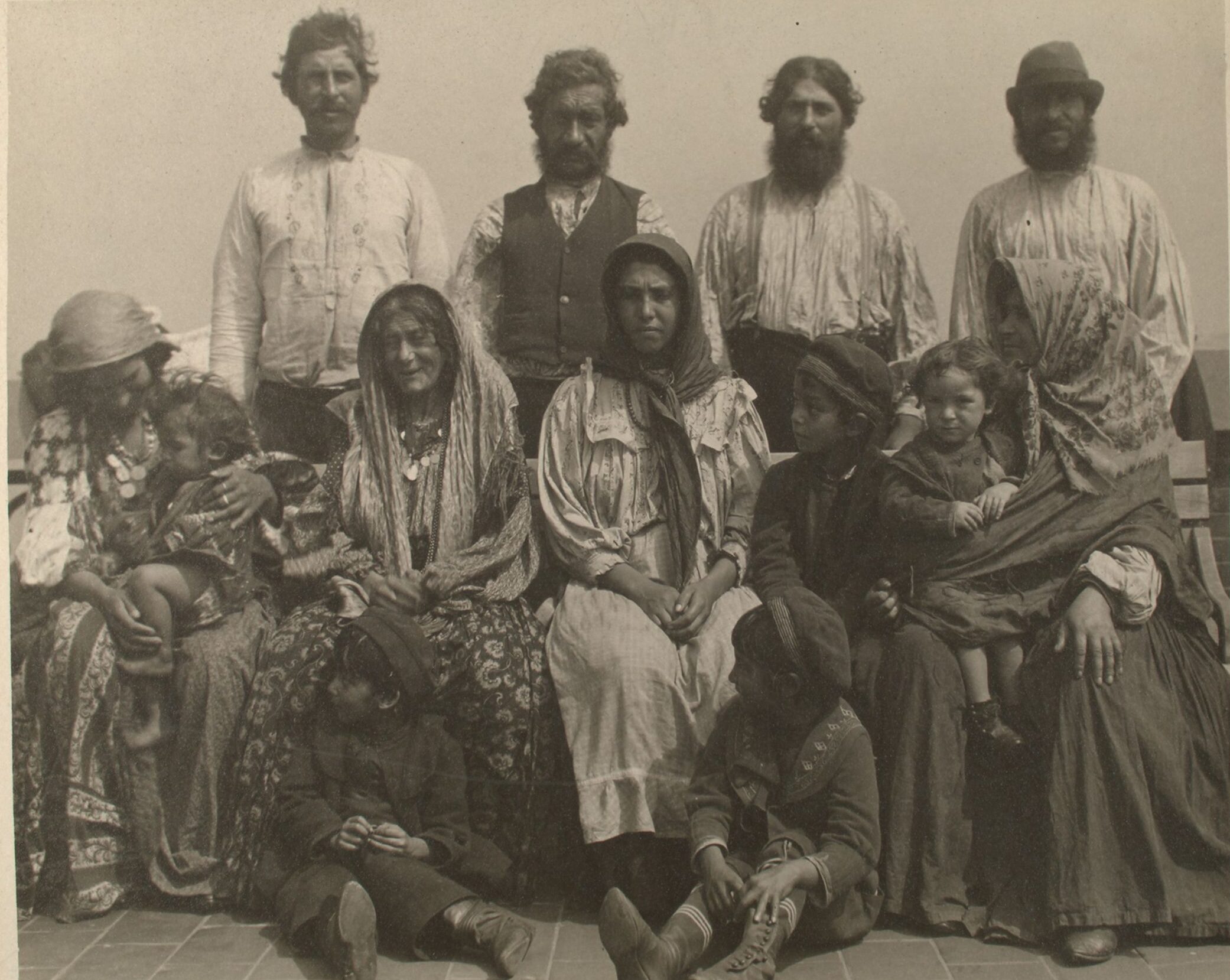 1904 sepia photo portrait of an extended Serbian Roma family