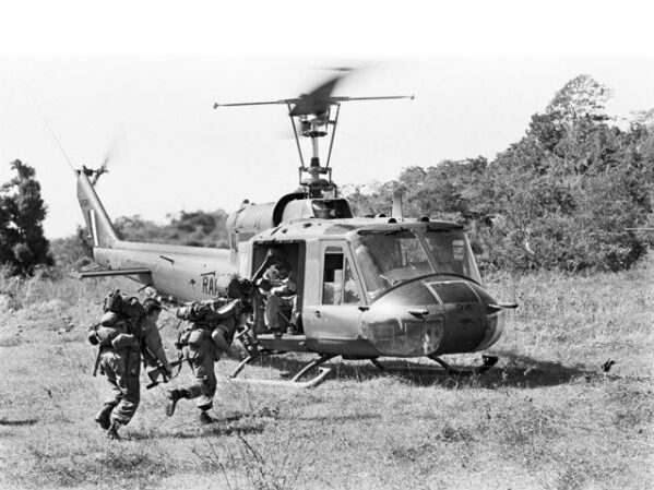Australian troops returning to the No 9 Squadron, RAAF, Iroquois helicopter A2-1024 after completing a sweep of the island where Viet Cong (VC) had been spotted 1966