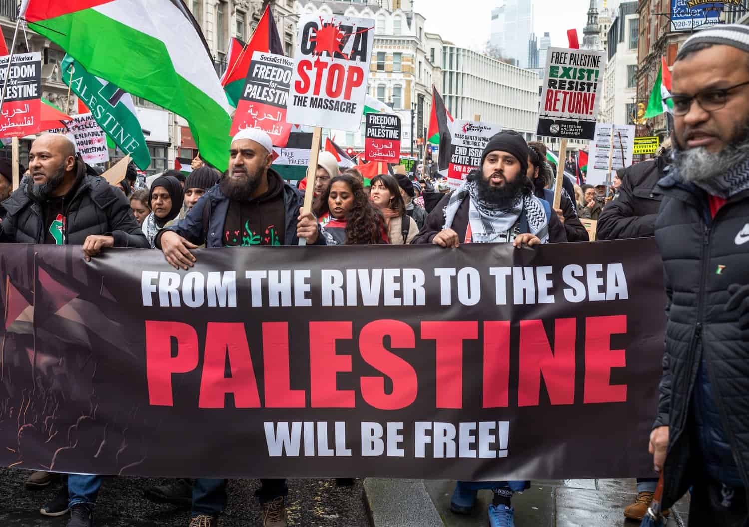 Protestors in London raise a banner reading "From the river to the sea, Palestine will be free" and call for an end to Israeli attacks on Gaza (December 9, 2023) | Andy Soloman / Shutterstock