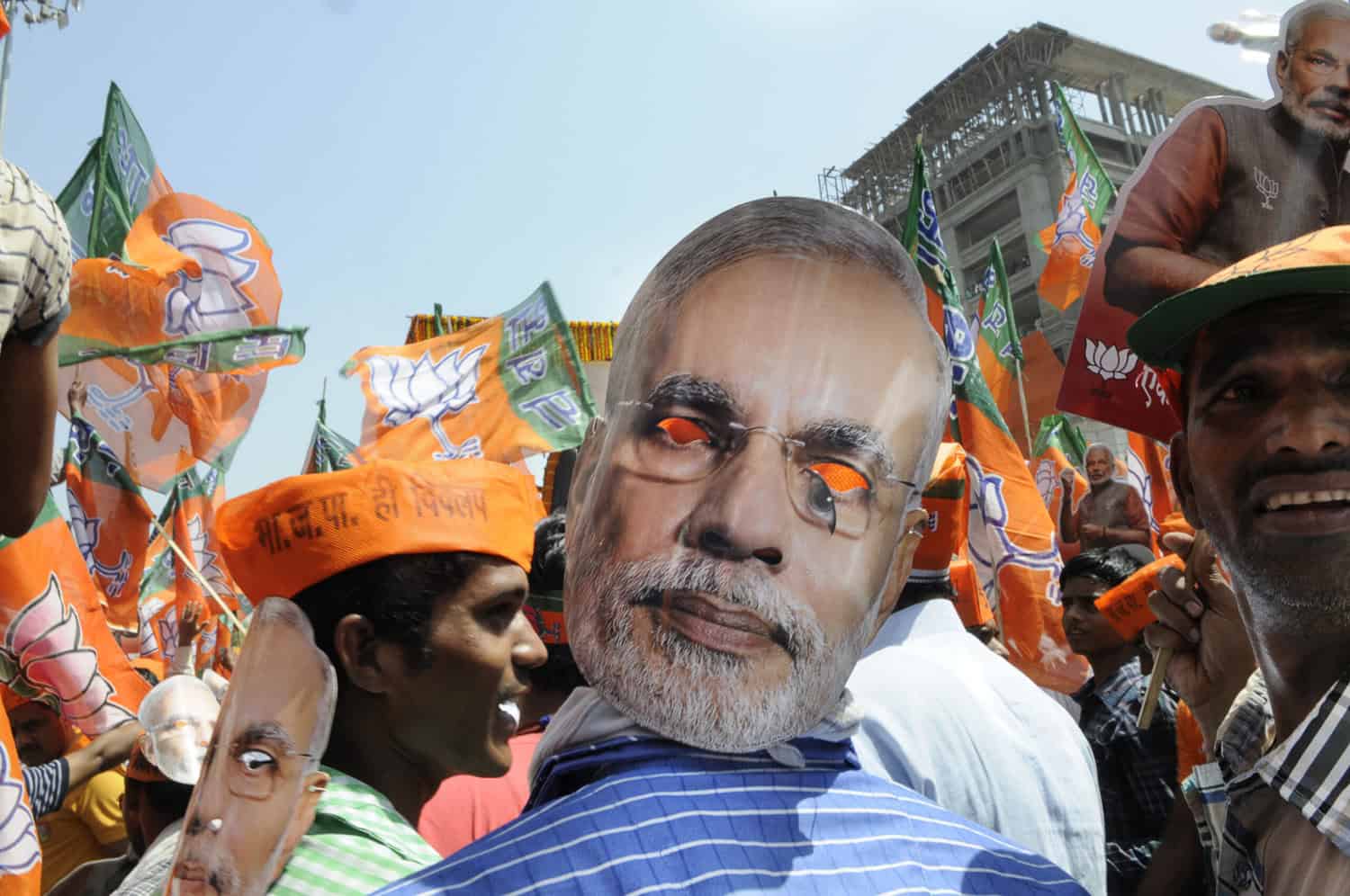 VARANASI-APRIL 24: A person with a Narendra Modi mask tied to his head facing back during a rally in his support on April 24, 2014 in Varanasi , India.