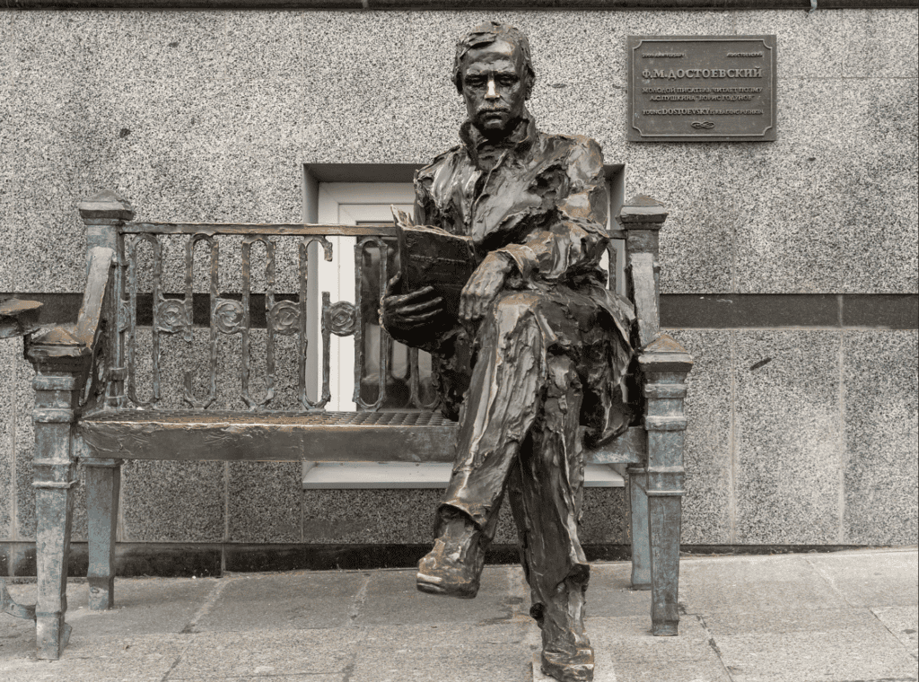 Statue of young Dostoevsy reading on public bench