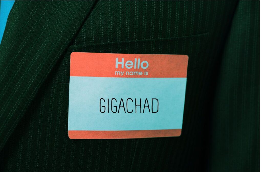 A red and white sticker on a jacket lapel reads "Hello My Name is Gigachad"
