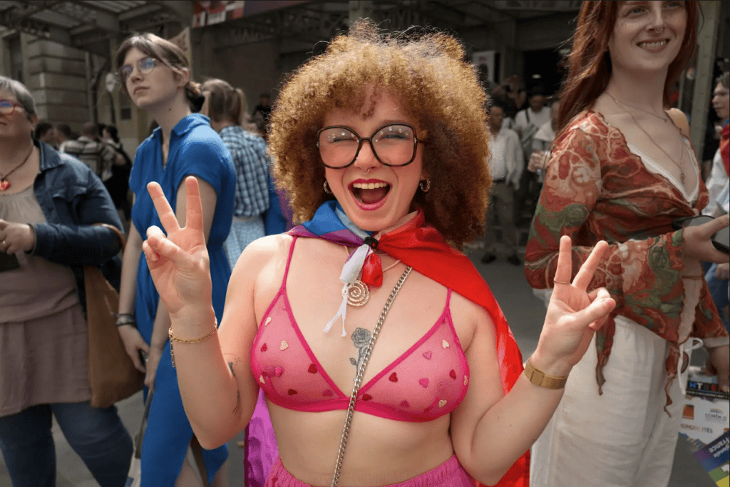 A young woman celebrating the official Marche des fiertés march