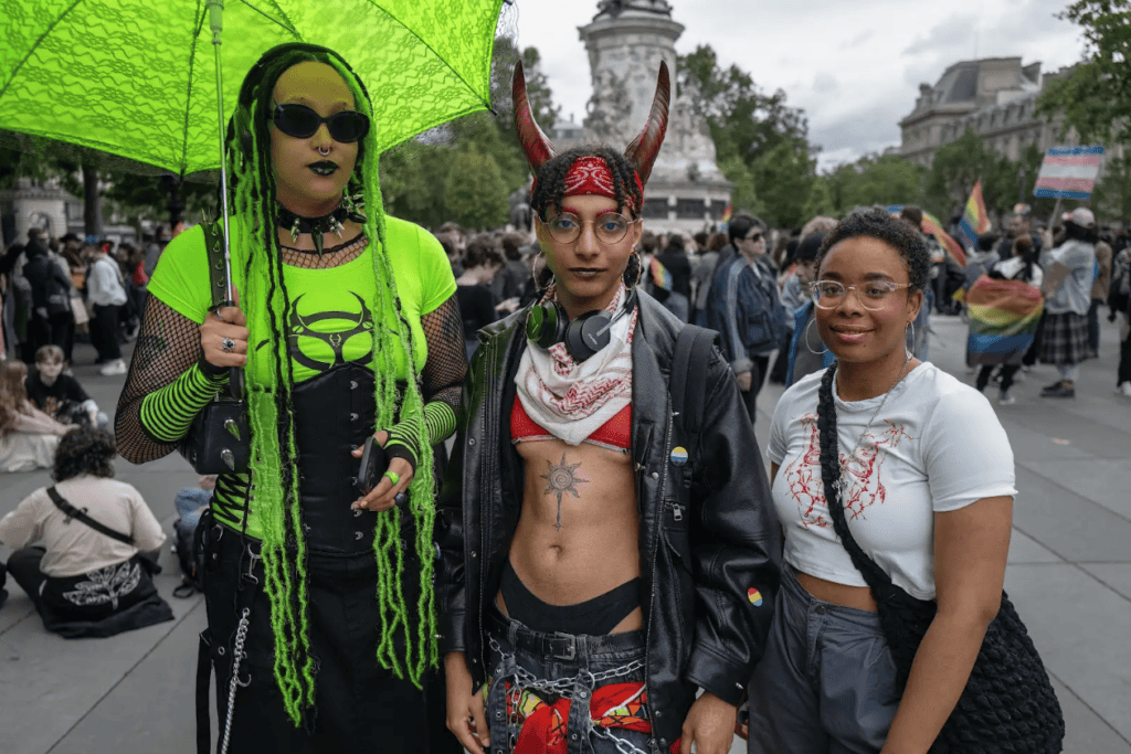 Three individuals getting ready for the Pride Radicale event