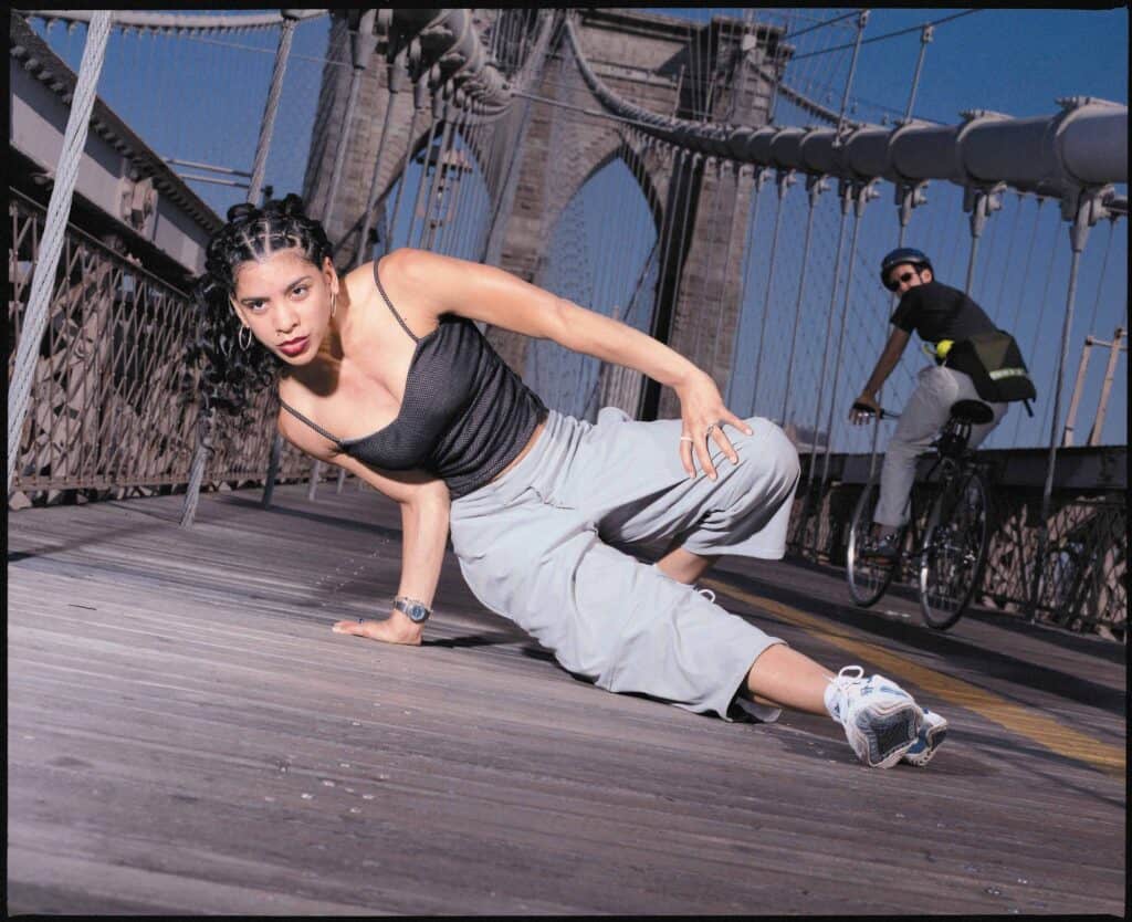 Woman in breakdancing pose on Brooklyn bridge