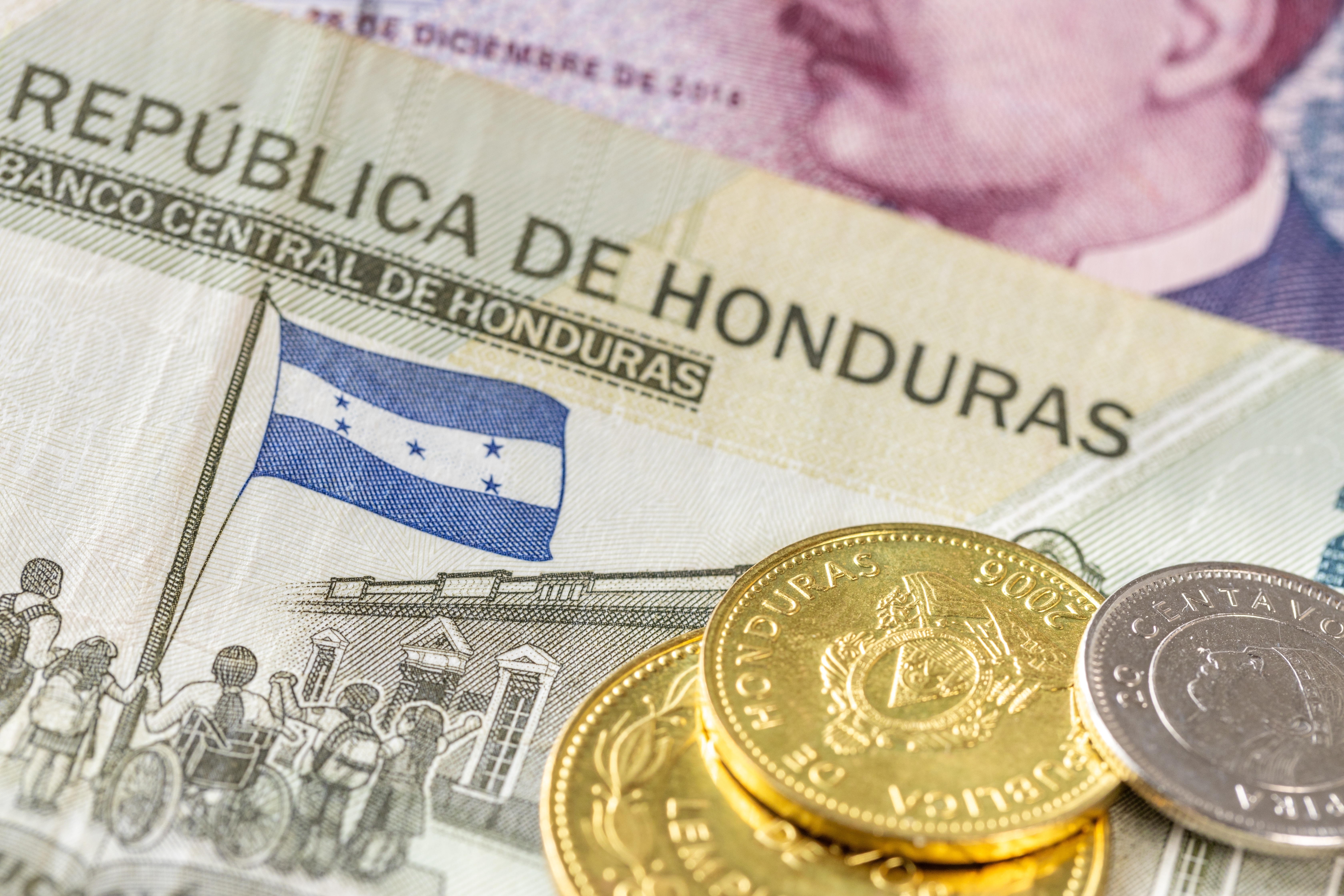 Honduras money “República De Honduras,” with financial business concept, banknotes and gold coins in the foreground.