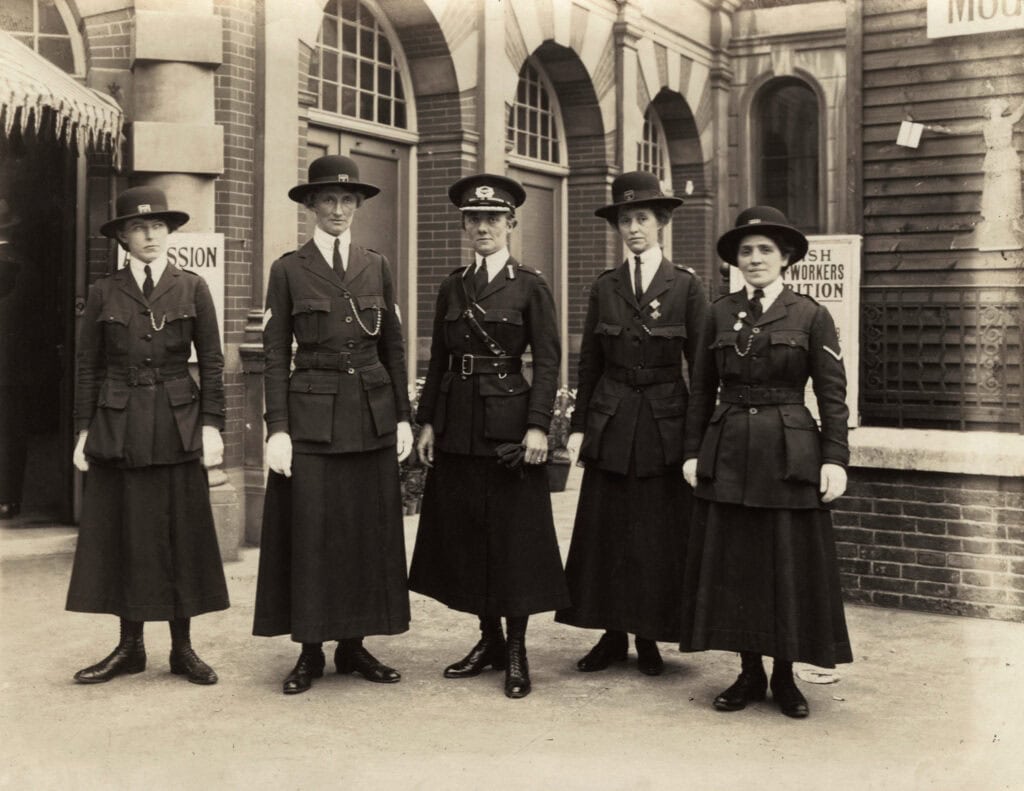 Black and white photograph of five early nineteenth century policewomen in uniforms that include long skirts
