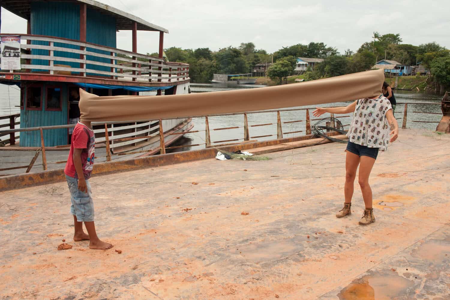 Kids playing with fabric on a pier in Brazil