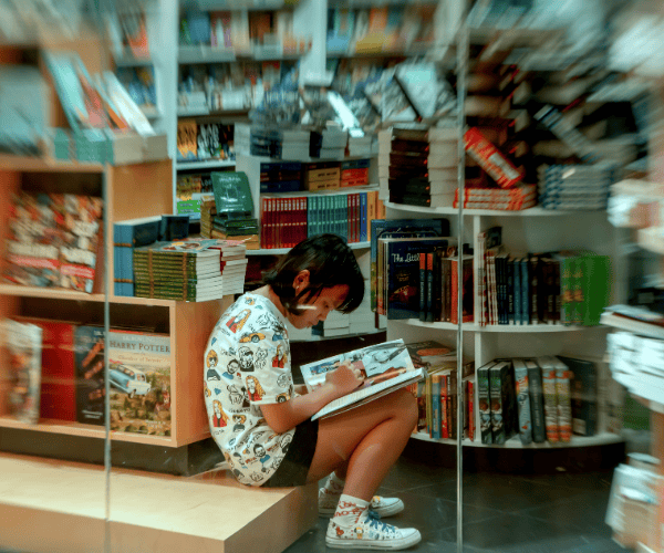 Girl Writing in Bookstore