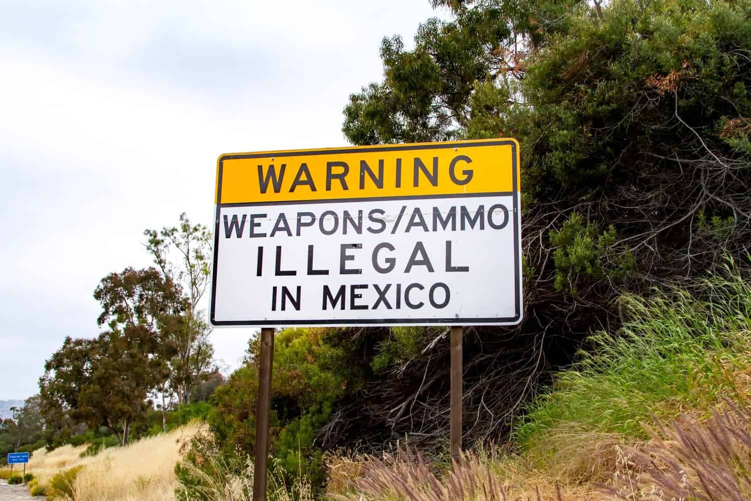 Sign on 5 freeway in San Diego warning that it is illegal to carry weapons or ammunition into Mexico