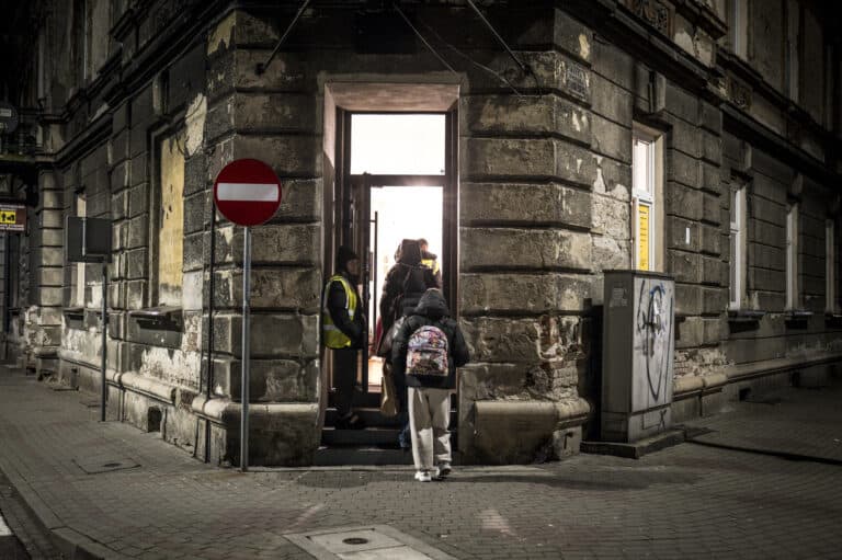 Ukrainian women and children arrive at the train station in Przemyśl, Poland, and are guided by aid workers and volunteers to a nearby safe house after fleeing Russia’s war in Ukraine. November, 2025 | Nancy Richards Farese