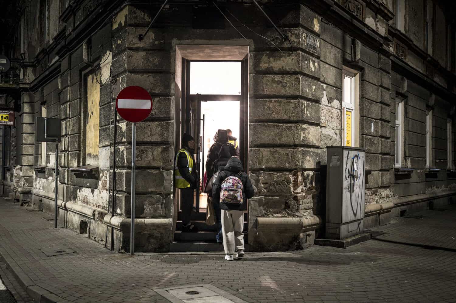 Ukrainian women and children arrive at the train station in Przemyśl, Poland, and are guided by aid workers and volunteers to a nearby safe house after fleeing Russia’s war in Ukraine. November, 2025 | Nancy Richards Farese