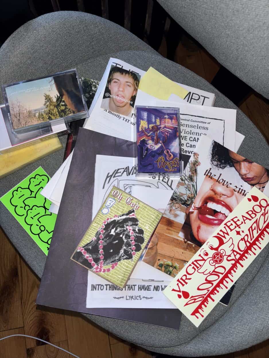 An assortment of magazines and other forms of physical media scattered on a chair