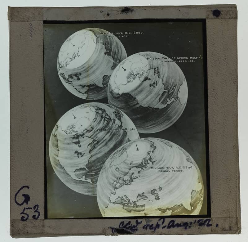 A lantern slideshows four overlapping illustrations of the Earth depicting its tilt at different time periods in the past, present and future. Dates represented are 13000 BC, 5544 BC, 1921 AD, 2296AD. Handwritten in blue ink at bottom left corner of plate is the text 'G53 CLW [illegible] Aug '22'.