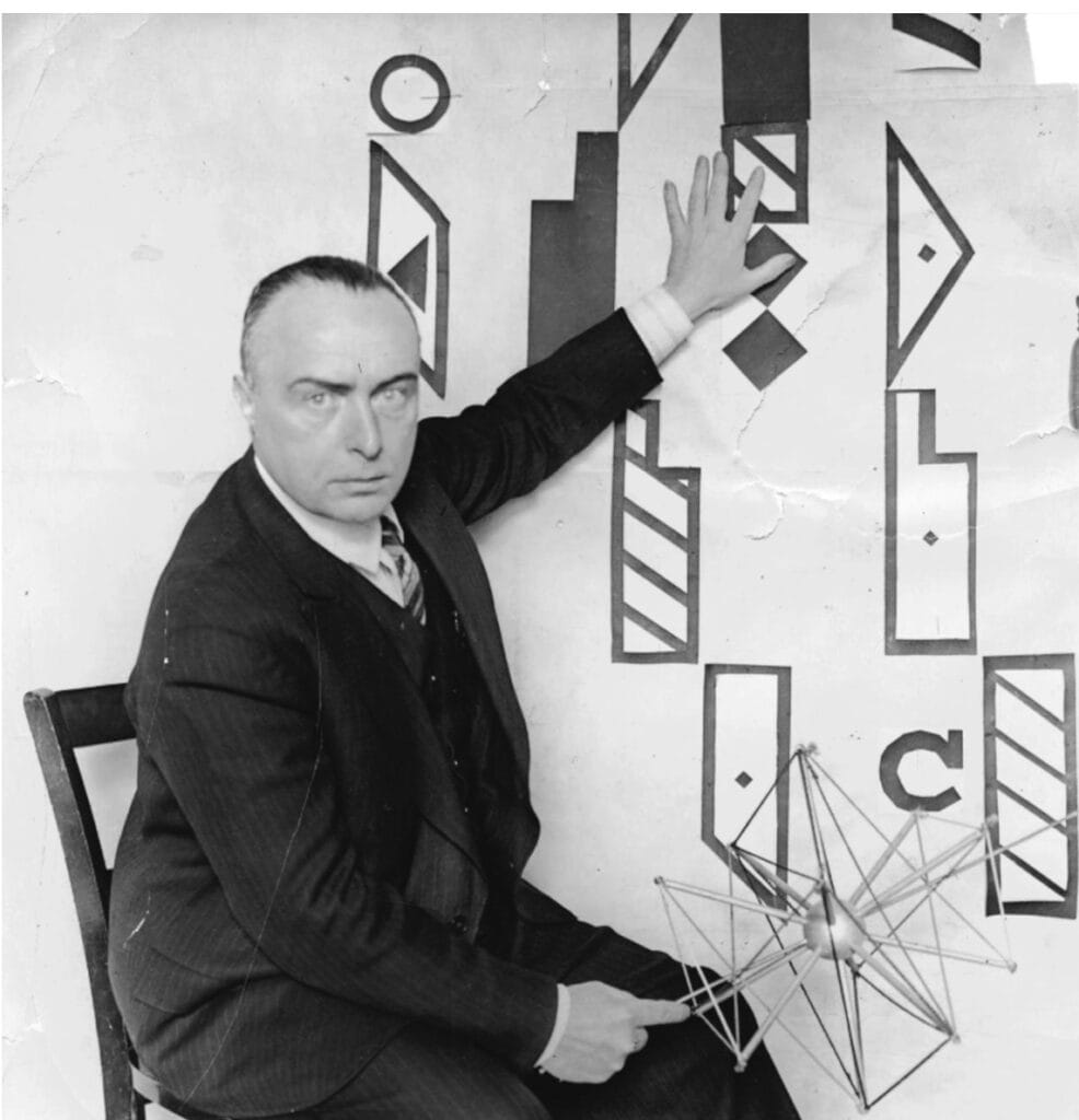Rudolf von Laban sits next to his Labanotation signs.