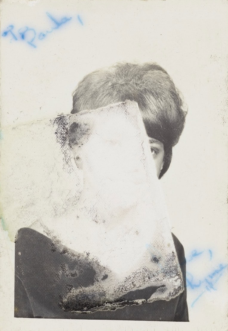 A black and white photograph of an unidentified woman. Most of the portrait has been worn away. There is an inscription in blue ink on the front of the photograph: [To Paula, / Love, Lynne]. The back of the photograph has blue ink and the remnants of what was some notation that has worn away.