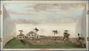 A diorama showing a sugar plantation in Suriname. Low buildings line the background, with one large house rising above the rest. A few scrubby trees and windswept palms dot the scene, and slaves can be seen working. The diorama’s background is a painted blue sky with puffy white-and-gray clouds.